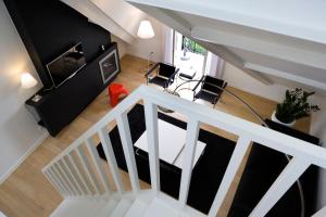 奥斯坦德利奥波德5豪华设计公寓的客厅享有高空美景,设有白色的楼梯