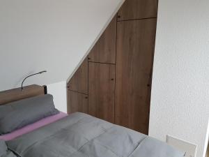 克桑滕DOMizil Xanten的一间卧室配有一张床和一个木制橱柜