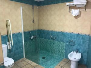 韦斯卡尔Hotel Patri的带淋浴、卫生间和盥洗盆的浴室