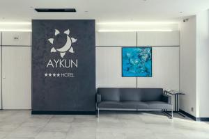 阿斯塔纳AYKUN Hotel by AG Hotels Group的墙上有标牌的沙发