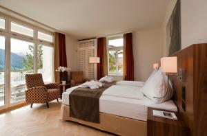 达沃斯Waldhotel & SPA Davos - for body & soul的一间卧室设有一张床和一个大窗户