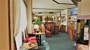 米兰阿库希奥酒店的大堂,设有红色的椅子和桌子