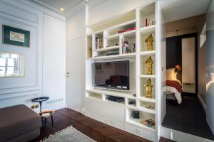 梅斯L'Appartement des Roches的客厅设有电视,位于白色书架上