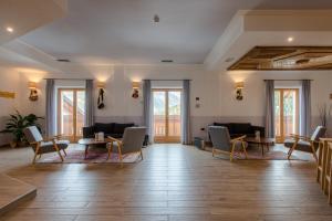 瓦尔迪登特罗Hotel San Carlo, tra Bormio e Livigno的大型客房设有桌椅和窗户。