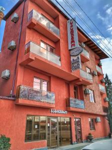 库塔伊西欧罗巴住宿加早餐酒店的一面有标志的红色建筑