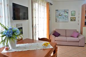 包内伊Appartamento Sa Plassa的客厅配有桌子和沙发