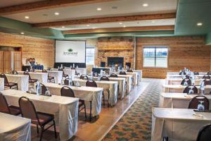 巴克斯特布雷纳德湖阿罗伍德酒店的一间设有白色桌椅的用餐室