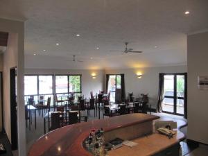 纳皮尔棕榈城汽车旅馆的餐厅设有酒吧和桌椅