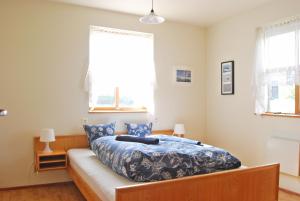 霍尔斯沃德吕尔维斯特里嘉德萨基酒店的一间卧室配有一张带蓝色棉被的床