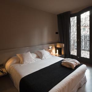 瓦伦西亚卡罗酒店的卧室配有一张大白色床和窗户