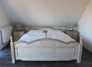 Neuendorf HeideFerienhaus Harmonia的一间卧室配有白色床和2个床头柜