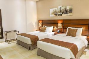 Q Suites Jeddah by EWA - Managed by HMH客房内的一张或多张床位