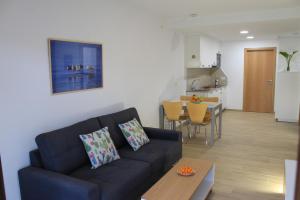 格罗韦Apartamentos As Lagoas的带沙发的客厅和厨房