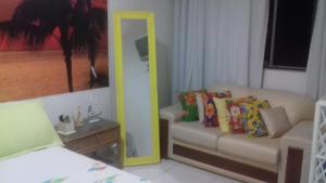 盖比姆Ap aluguel no Guaibim的客厅配有镜子和沙发