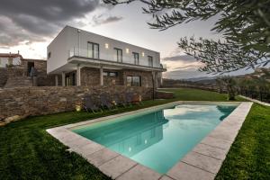BarcelLongra Family Villa & SPA的房屋前有游泳池的房子