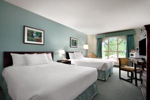 哈里森温泉哈里森湖酒店的酒店客房配有两张床和一张书桌