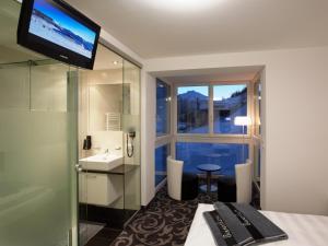 伊施格尔Ischglliving Appartements的酒店客房设有带水槽和窗户的浴室