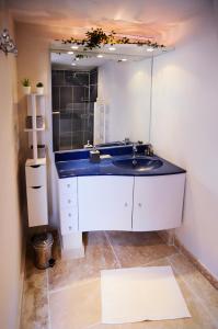 阿普特Côté Terrasse的一间带水槽和大镜子的浴室