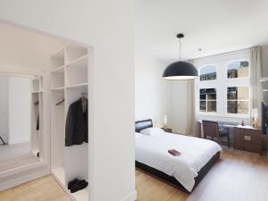 杜塞尔多夫红色公寓酒店的一间卧室配有一张床和一个步入式衣柜