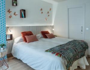 萨拉曼卡Homely Salamanca的卧室配有带枕头的大型白色床