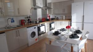 剑桥The Mill Suites - Tas Accommodations的厨房配有桌椅和水槽