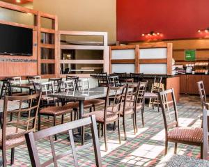 芒特普莱森特会议中心康福特茵酒店的一间带桌椅和电视的用餐室