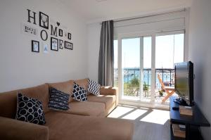坎布里尔斯La Torre Oceanside的带沙发和大窗户的客厅