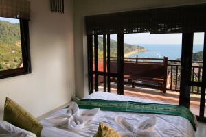 高兰Baan KanTiang See Villas - SHA Extra Plus的一间卧室设有一张床,享有海景