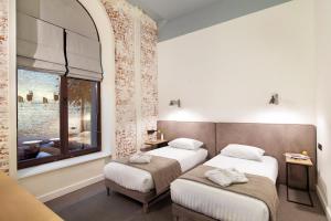 利沃夫FERENC Hotel & Restaurant的酒店客房设有两张床和窗户。