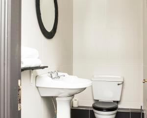 克罗巴里卡农酒店的一间带水槽、卫生间和镜子的浴室