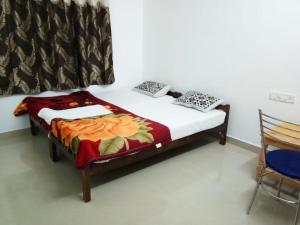 提喀迪Spice Cottage Homestay的卧室配有一张床,位于带椅子的房间