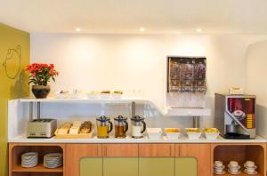 墨尔本福克纳宜必思快捷酒店的厨房配有带食品和饮料的柜台