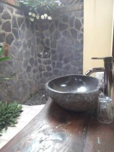 佩母德兰彭多克拉哈余旅馆的石墙浴室内的石水槽