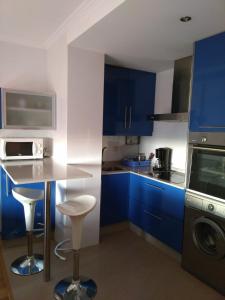 坎巴多斯Cambados Apartamento VUT-PO-TU986D的厨房配有蓝色橱柜和台面