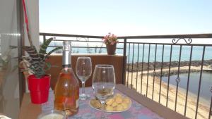内塞伯尔阿克罗蒂里亚海滩公寓大楼 的一张桌子,上面放着两杯酒和一瓶葡萄酒