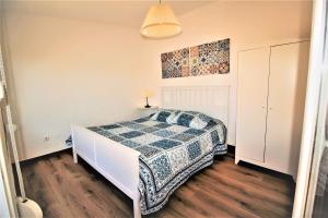 埃尔瓦斯Terraços de Elvas II的一间卧室配有一张带蓝白色毯子的床