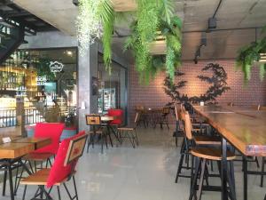 奥南海滩Maneetel Krabi Beachfront-SHA Plus的餐厅设有木桌和红色椅子
