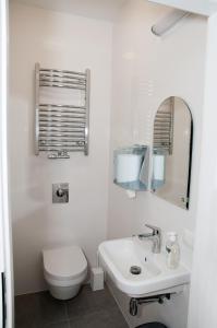 卢布林Rodmos Hostel的白色的浴室设有卫生间和水槽。