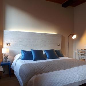 蒙特罗索阿尔马雷贝拉姆布拉酒店的一间卧室配有一张带蓝色枕头的大床