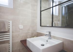 雷岛圣玛丽Maison d’hôtes Les Ajoncs的浴室设有白色水槽和镜子