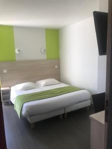 拉查佩里圣鲁布里特鲁瓦精萃机场酒店的一间卧室配有一张绿色和白色的床