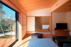 京都Aoi Suites at Nanzenji Modern & Traditional Japanese Style的客房设有床和大窗户。