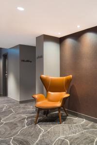 布里斯班杰甫逊公寓及酒店的墙上的橙色椅子