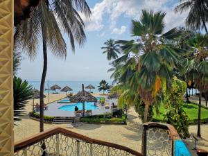 南威微笑海滩酒店 的享有带游泳池和棕榈树的度假村的景致