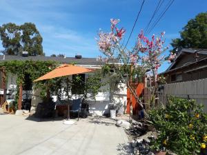 圣安娜OC House的房屋前带橙色遮阳伞的天井