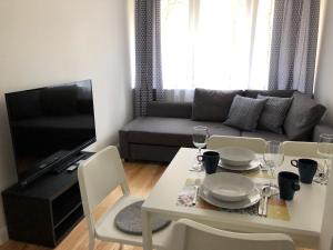 比亚韦斯托克CR Przytulny Apartament przy Pałacu Branickich的客厅配有桌子和沙发
