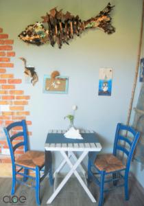 阿西亚罗利B&B PLANO DE LACZARULO的一张桌子、两把蓝色的椅子和一张桌子