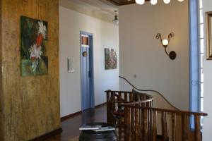 CristinaPOUSADA CASARÃO NORONHA KAUAGE的一间设有楼梯的房间,墙上挂着一幅画