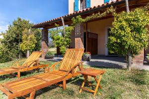 塞科夫列Residence Gold Istra的两把木凳坐在房子前面的草上