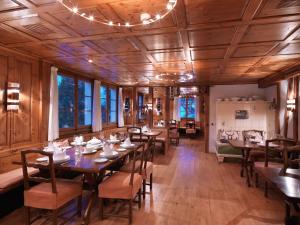 艾根塔尔汉默尔餐厅及酒店的一间铺有木地板并配有桌椅的用餐室
